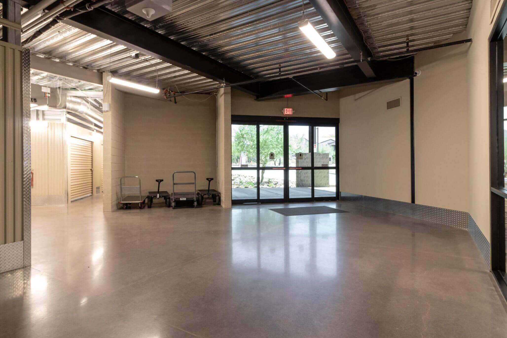 Smart storage layout at McDowell Mountain Community Storage Scottsdale Arizona featuring clear plastic bins and multifunctional furniture pieces for a minimalist home.